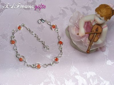 Orange glass bead treble clef music themed bracelet