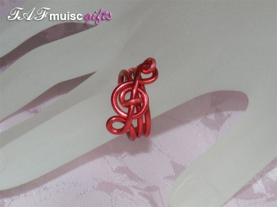 Red treble clef music themed statement ring