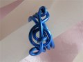 Blue treble clef music themed statement ring
